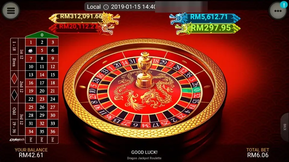 Dragon Jackpot Roulette wheel in red and gold with a carved dragon in the centre, a small betting grid on the left and four dragon jackpot counters at the top